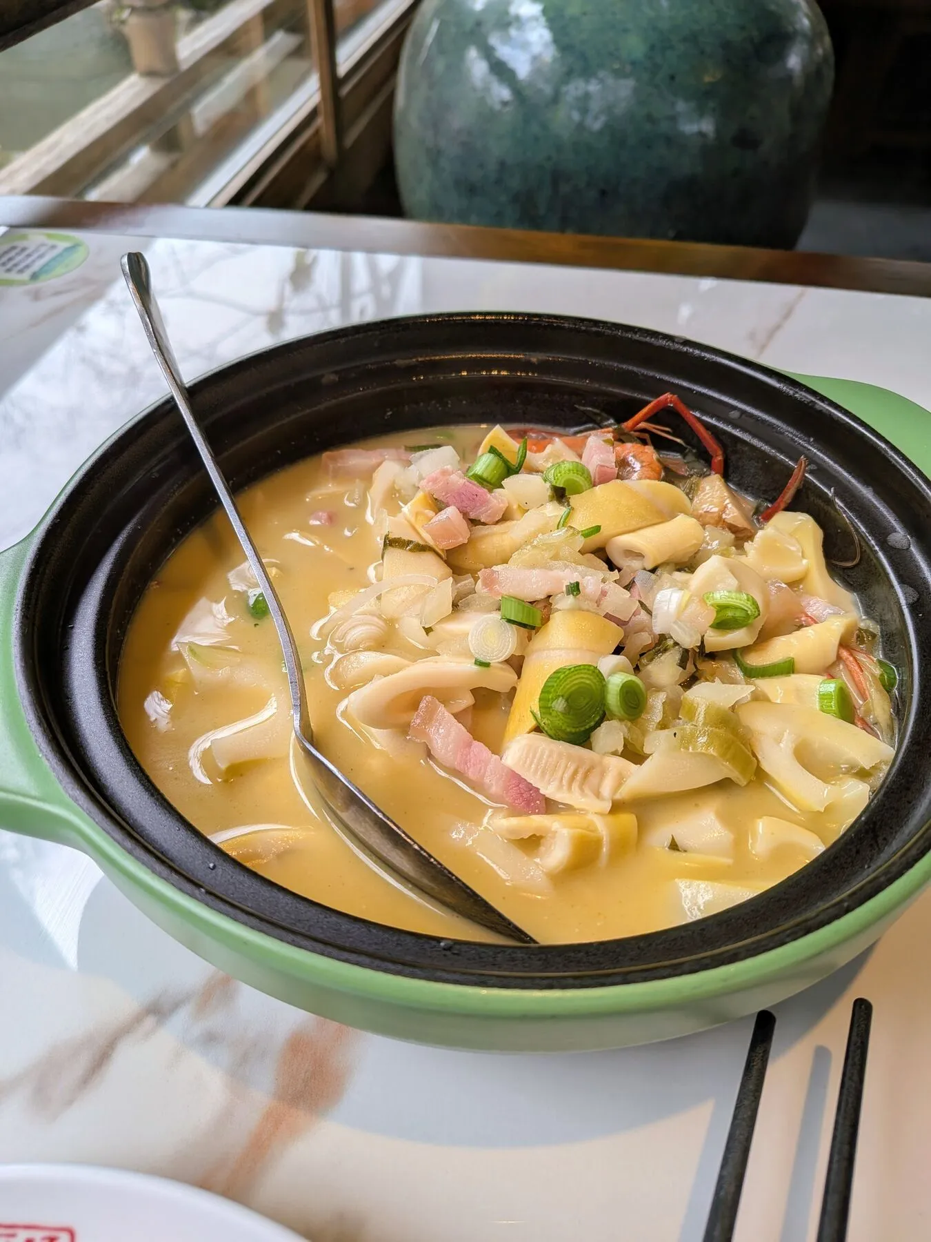 Soup with bamboo, pork-looking pieces, shrimp, and vegetables